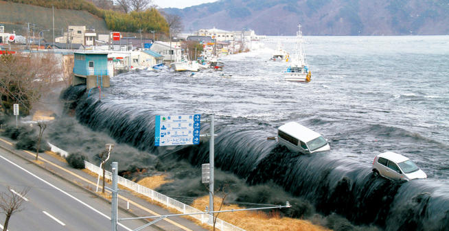 The tsunami, measured at one location at 128 feet, washes away cars as it approaches Miyako City. PHOTO: HITOSHI KATANODA/POLARIS